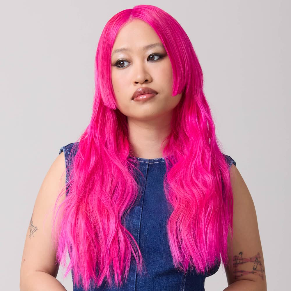 A model with long hot pink hair, wearing Good Dye Young color