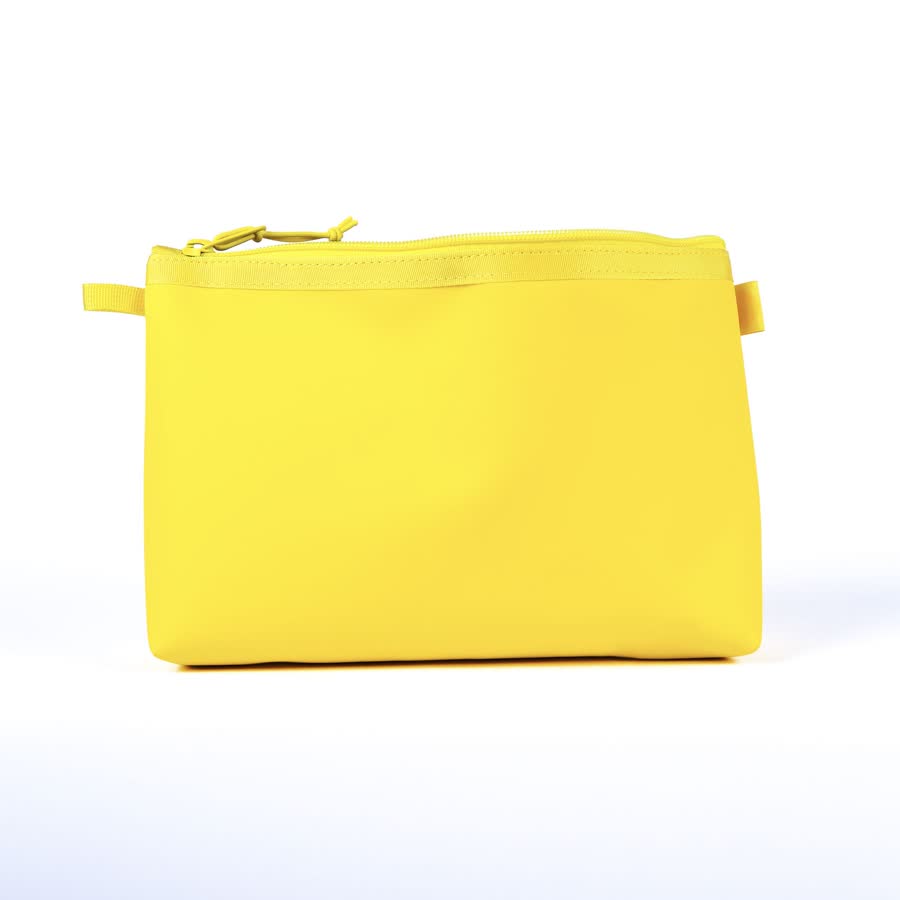 The sunshine-yellow Carry Your Pride dopp kit