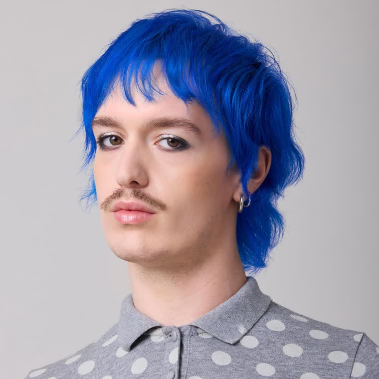 A model with vivid blue hair, wearing Blue Ruin