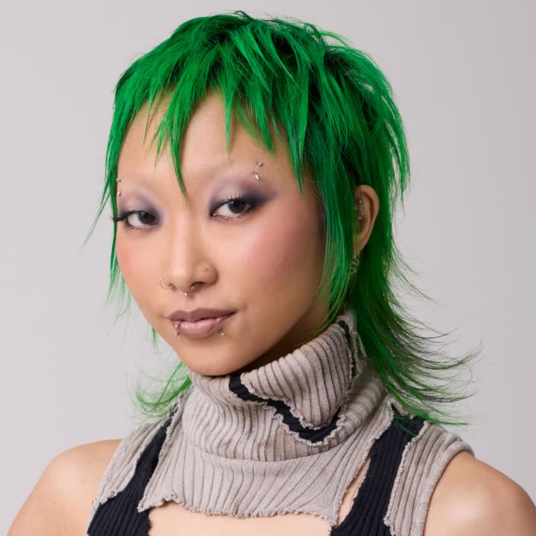 A model with a shaggy green cut, wearing Kowabunga
