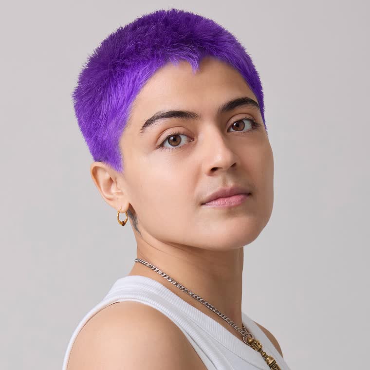 A model with a purple buzz cut, wearing PPL Eater