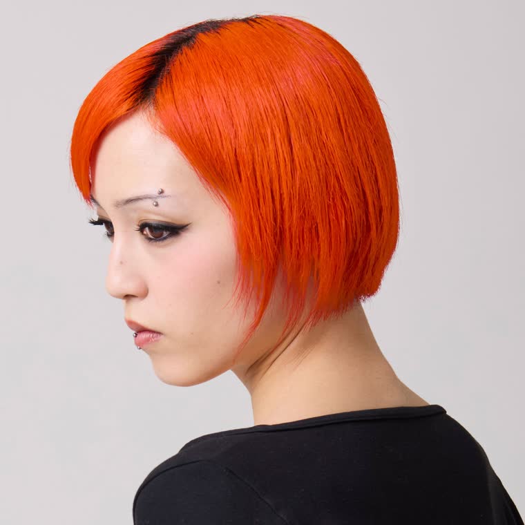 A model wearing Riot, a neon orange