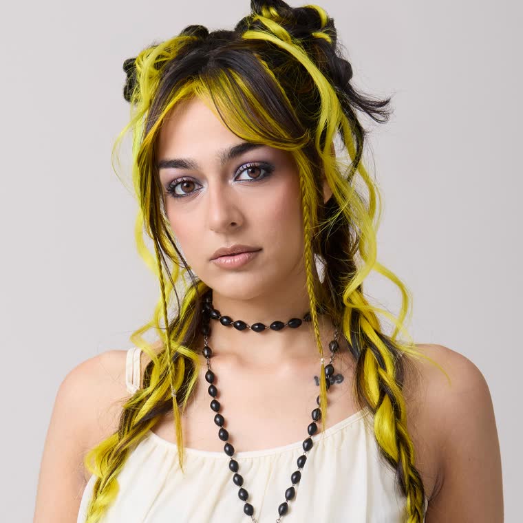 A model with yellow and black hair, wearing Steal My Sunshine